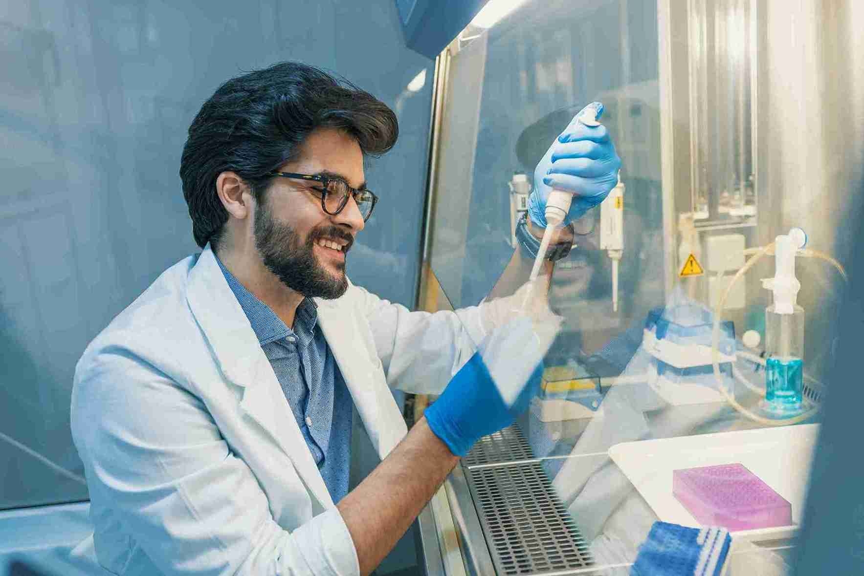 a young lab technician working on a lab sample