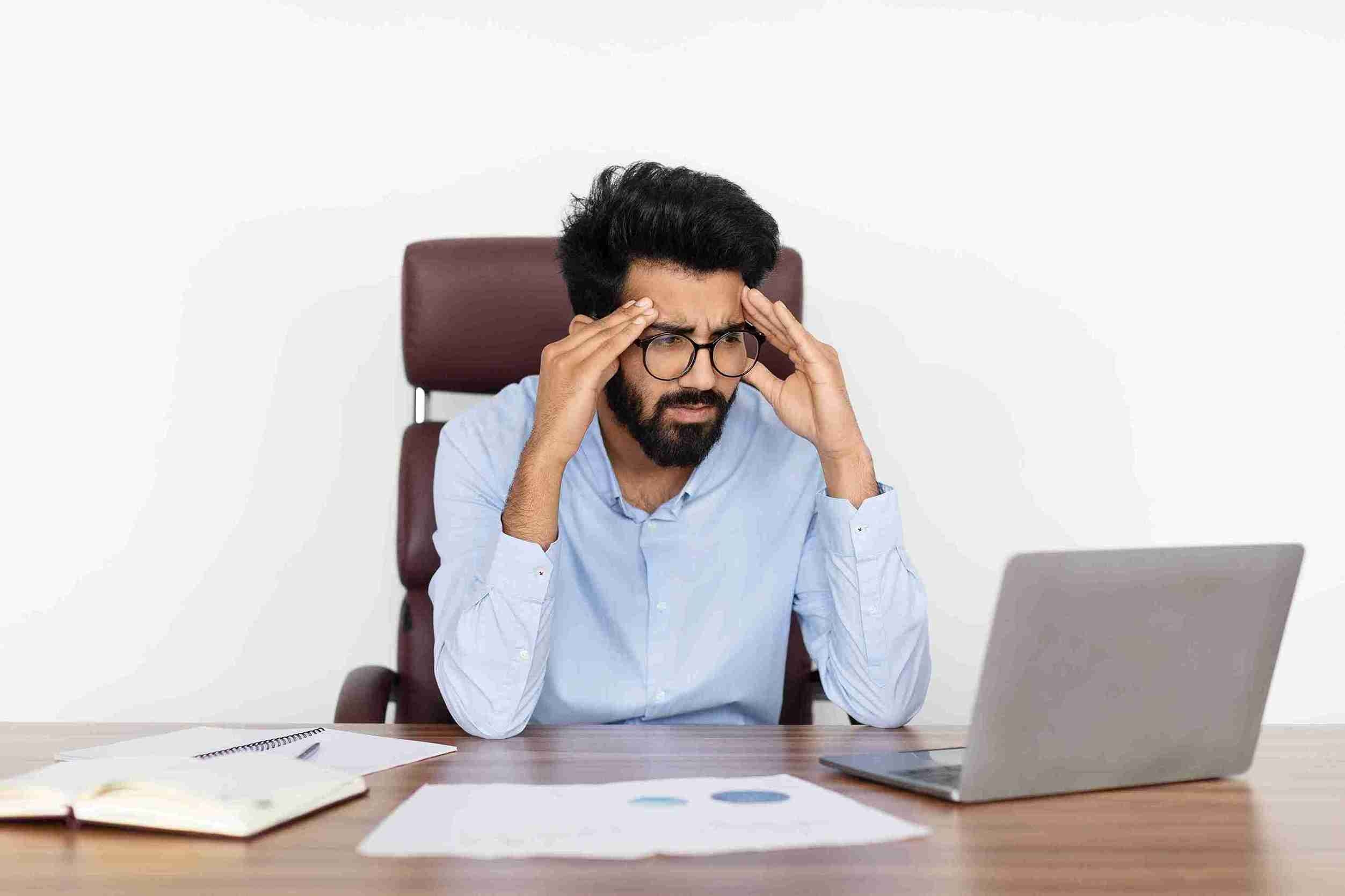 a stressed employee staring at a laptop