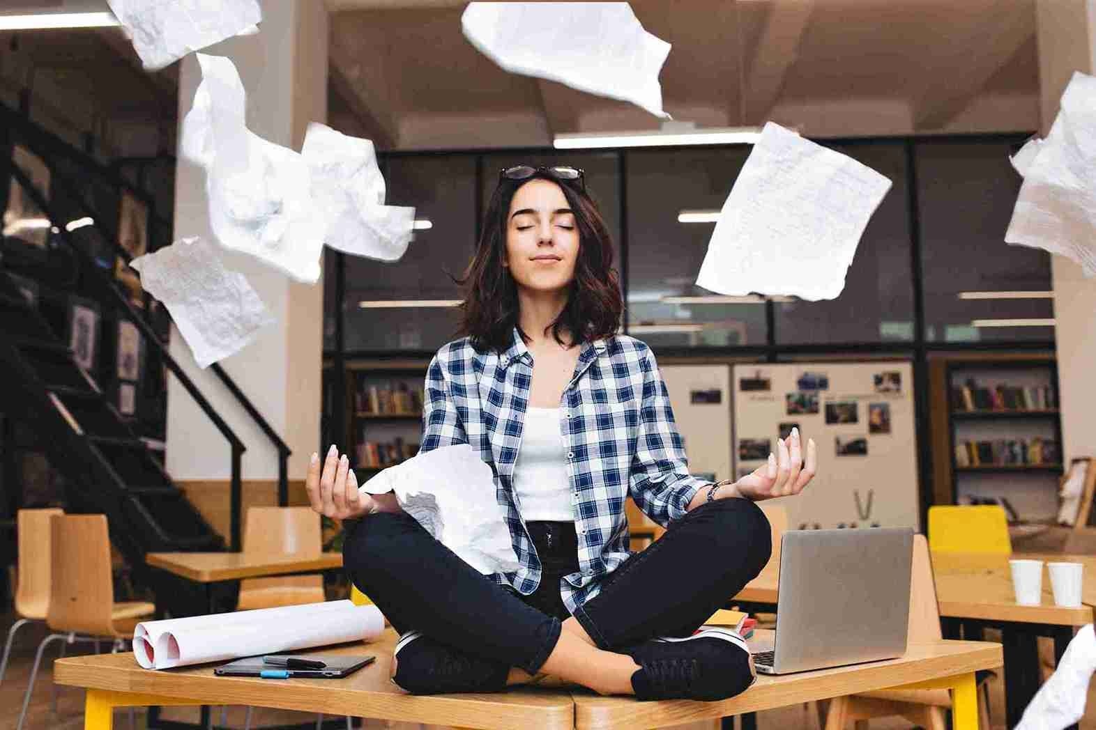 a young female employee meditating in office